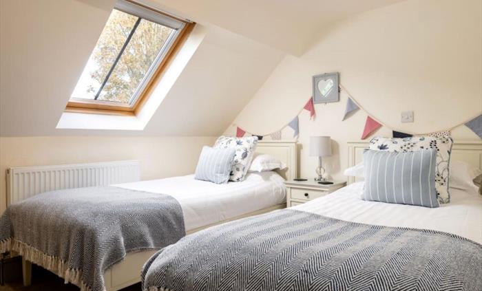 The upstairs bedroom has two fixed twin beds